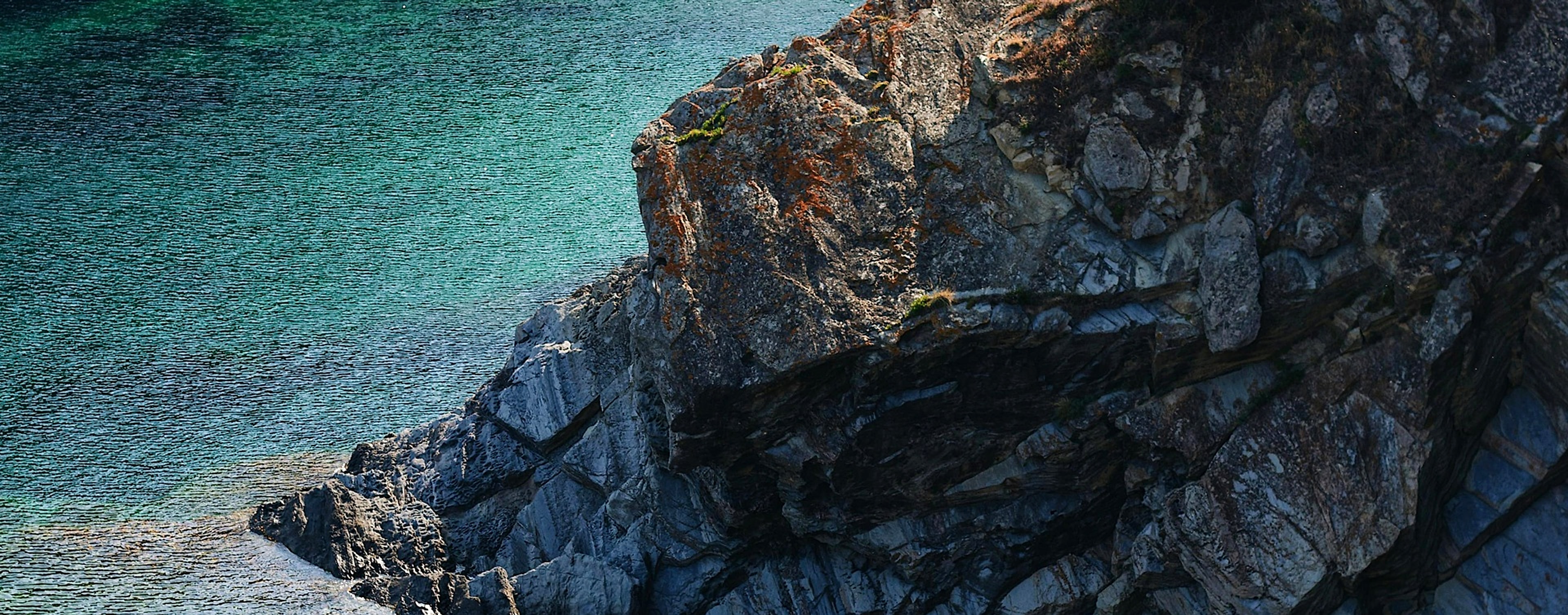 A rugged coastal cliff standing firm against the sea