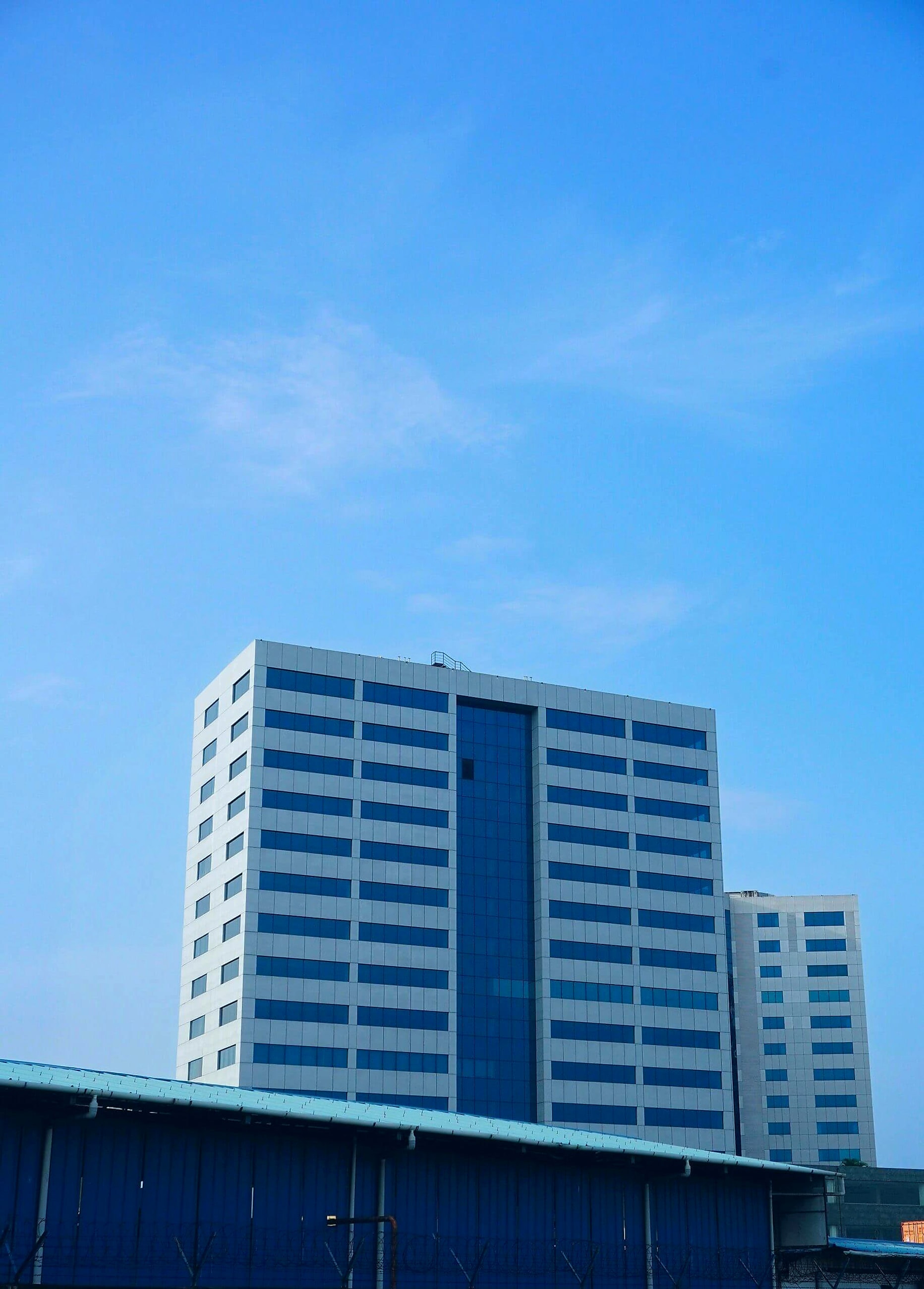 Modern glass towers against a clear sky — structure that endures
